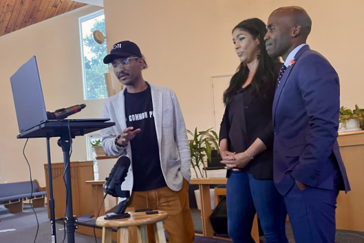 Three individuals stand inside a church during a 24-hour teach-in last week.