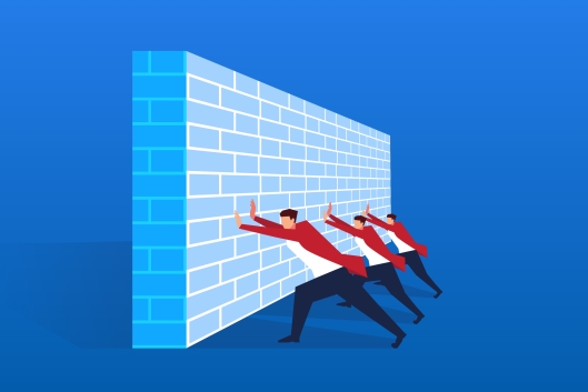 Three men push against a wall-like barrier 
