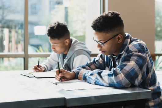 Two young men take an exam