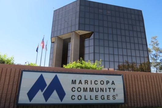 A sign reads “Maricopa Community Colleges” in front of an administrative building.