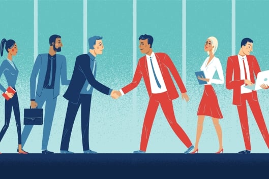 Two groups of diverse professionals meet and greet, one wearing red, the other blue