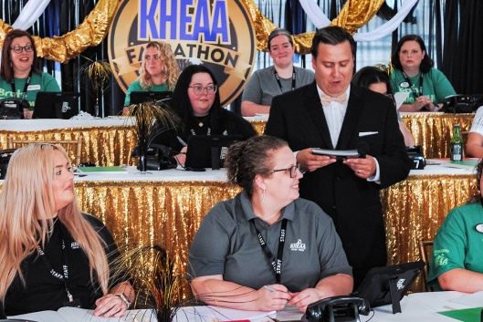 People at tables with gold trim and telephones
