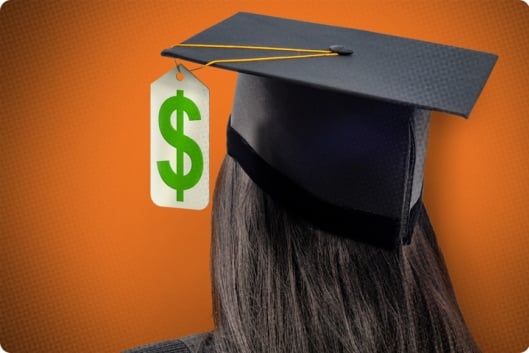 A student wearing a graduation cap with a dollar sign tag hanging from it instead of a tassel.