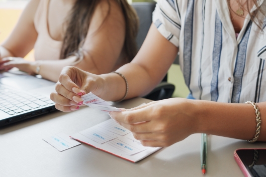 Two unidentified students study before class using flash cards