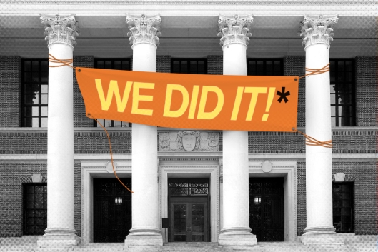 A sign saying "we did it" with an asterisk on a campus building