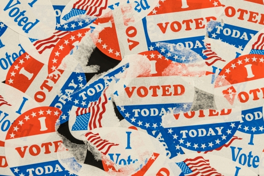Photo of many ripped and tattered "I voted today" stickers.