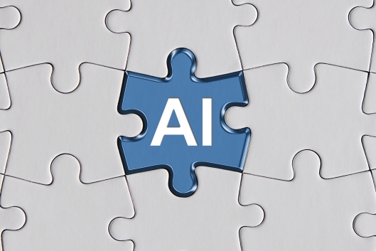 A blue jigsaw puzzle piece with the letters "AI" sits in the center of a puzzle; all the other pieces are white and blank.