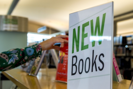 A sign reading "New Books" is displayed at a library.