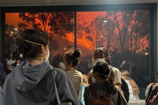 Pepperdine University students wear N-95 masks while watching the Franklin fire creep toward the Malibu campus.