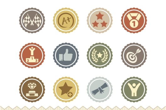 A slate of 20 different badges signifying achievement, featuring various images including trophies and a thumbs-up.