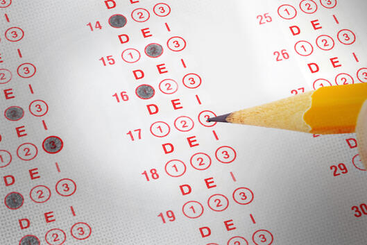 A scantron answer sheet with a pencil filling in some of the bubbles, but instead of being labeled A, B, C, the bubbles are labeled D, E, I.