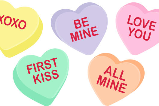 An illustration of five Valentine's Day–themed candy hearts, of different pastel colors, with messages variously saying "XOXO," "Be Mine," "Love you," "All Mine" and "First Kiss."