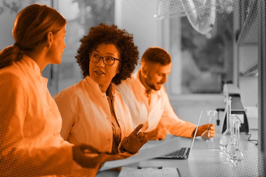 Photo illustration of scientists reviewing documents