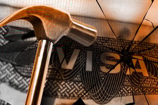 An illustration of a hammer smashing a visa.