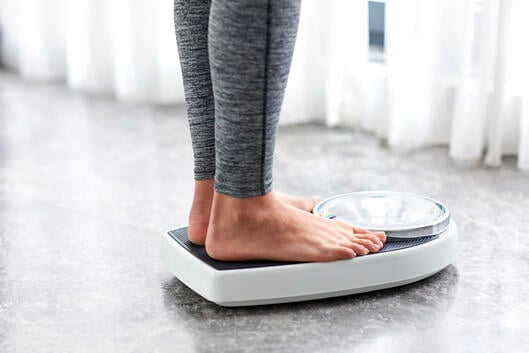 Young girl on home scale