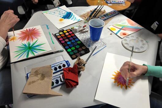 Students practice mindfulness techniques while painting with watercolors