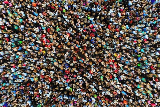 A photo of a large crowd of people gathered in one place, taken from overhead with a drone.