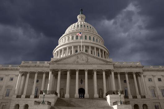 A photo of the U.S. Capitol building against a dark sky. 