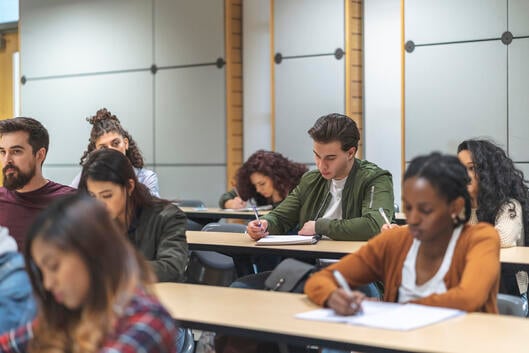 A multiethnic group of students listen in lecture