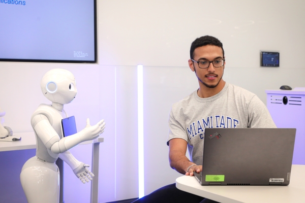 Miami Dade College student with robot