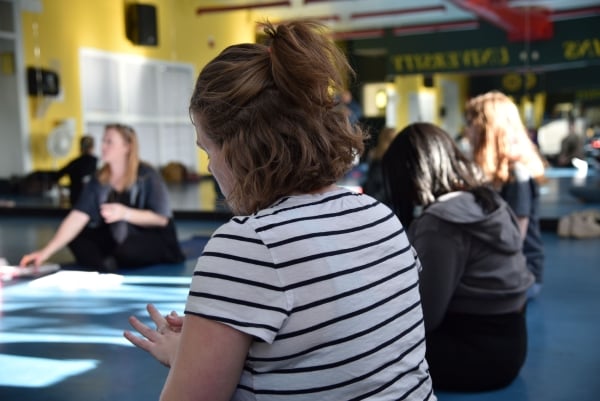 A group of students participates in guided meditation.