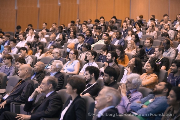 An auditorium full of people listening to a talk.