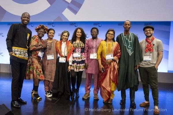 Young researchers wearing traditional attire from a range of home countries.
