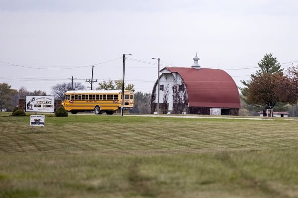 A bus drives on a rural Missouri backroad