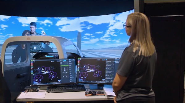 A flight instructor works with a student at California Baptist University