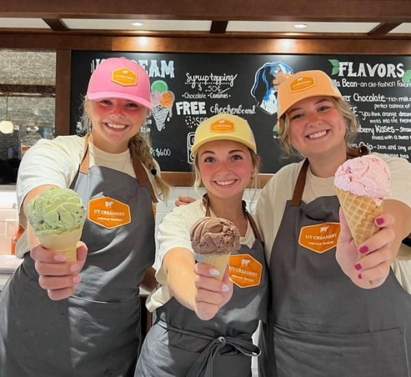 Three student employees smile with ice cream cones at UT Knoxville