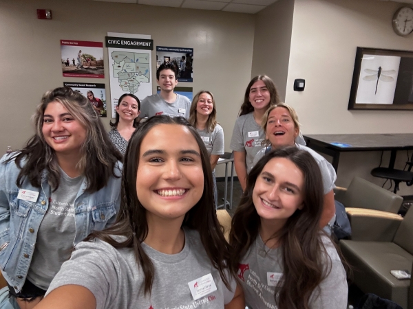 The North State Student Ambassadors smile for a selfie in the library