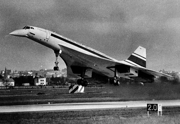 A black and white photo of a plane with a bent nose poised for takeoff. 