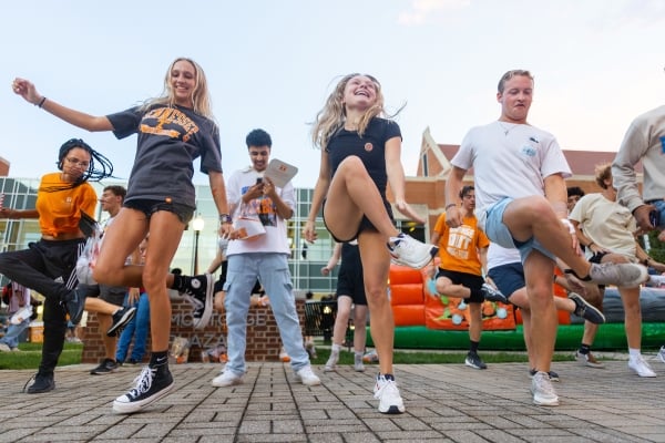 A group of students do a line dance on UT Knoxville's campus during Tennessee Saturday Night.