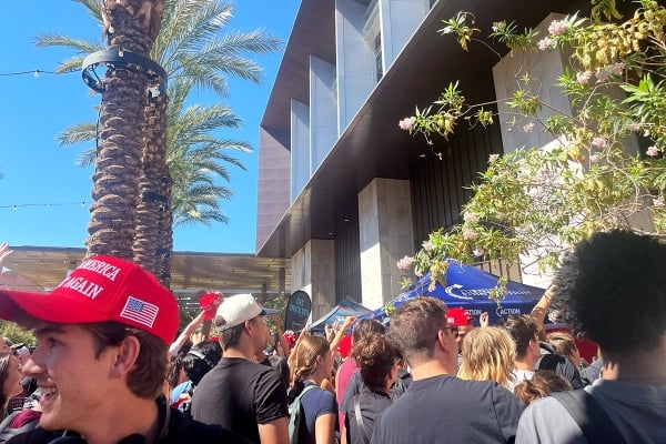 People wearing red Trump hats