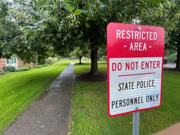 A red and white sign at what was previously Cazenovia College reads "Restricted Area: Do Not Enter: State Police Personnel Only."