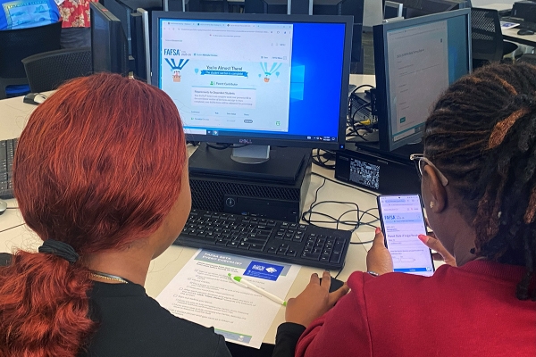 Two students over a screen