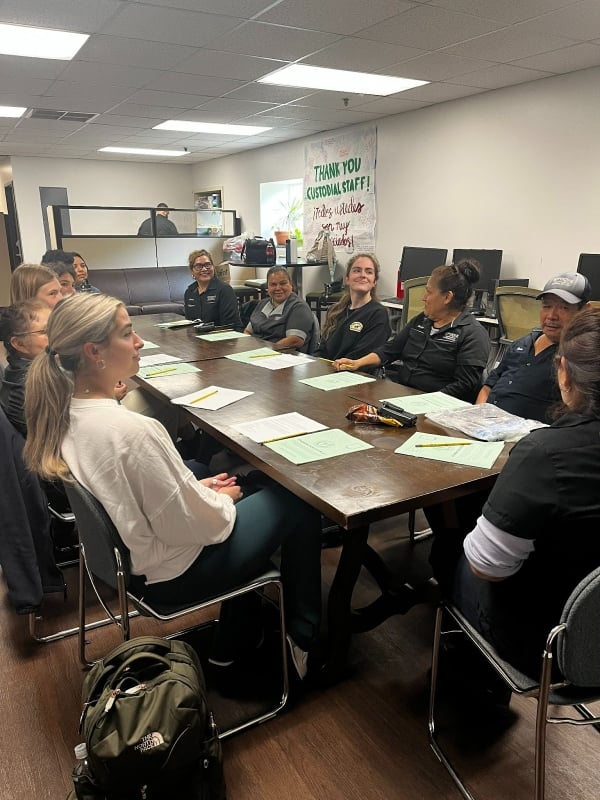 Facilities staff members meet for an ESL class on campus at Pepperdine University. 
