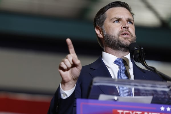 JD Vance speaks into a microphone
