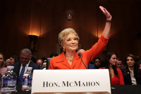 McMahon wearing an orange suit at her confirmation hearing