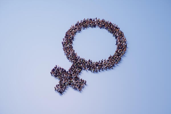 An illustration of the female symbol, made up of a crowd of people.
