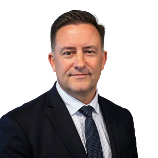 James DeVaney, a light-skinned man with short dark hair wearing a suit and tie.