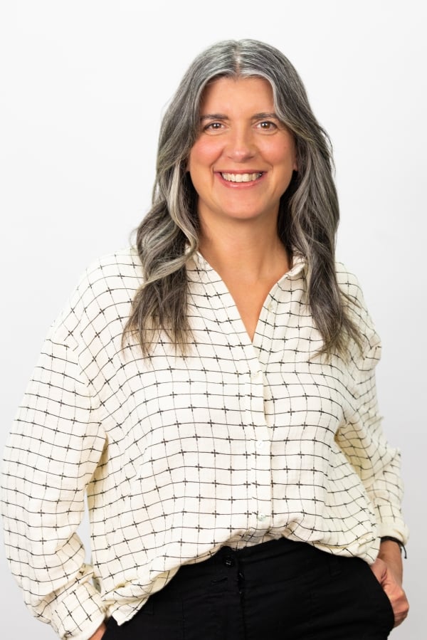 Marni Baker Stein, a light-skinned woman with gray hair wearing a printed button-down blouse.