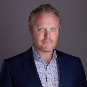 Steve Mildner, a light-skinned man with a ruddy complexion, a blond beard and light hair, wearing a blue blazer and a collared shirt without a tie.