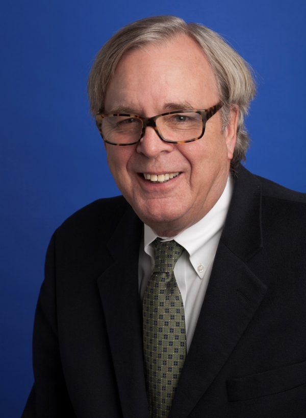 Peter Smith, an older light-skinned man wearing glasses and a business suit.
