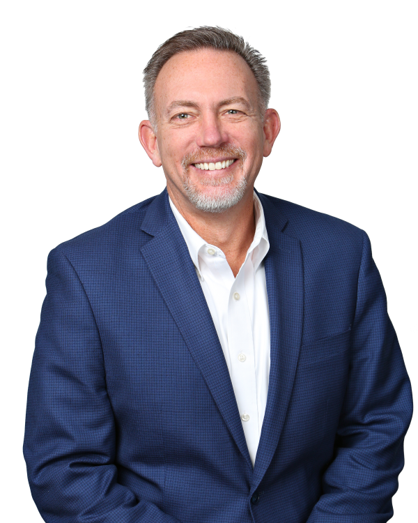 A light-skinned man with a gray goatee wearing a blue suit jacket and white button-down shirt.