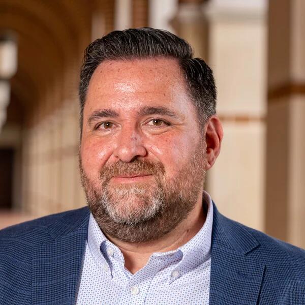 A photo of Shawn Miller, a ruddy-skinned man with brown hair and a beard.