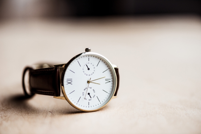 A photo of an analog wristwatch on a table.
