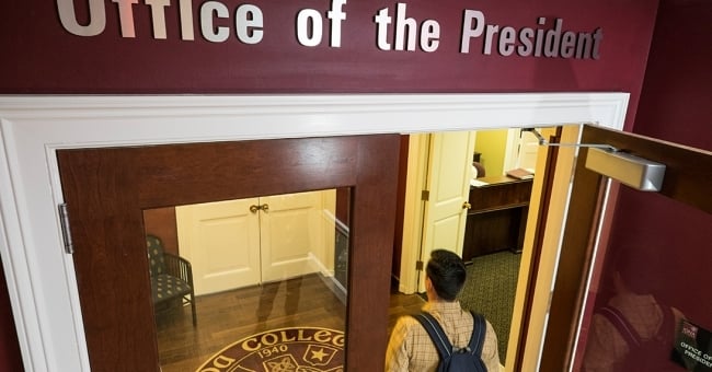 Student entering a president's office