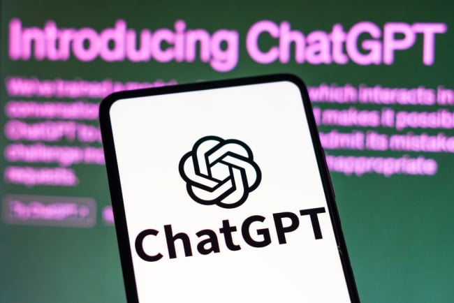 A drawing of a mobile phone with the "ChatGPT" logo in front of a dark screen with "Introducing ChatGPT" typed in purple text.