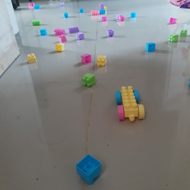 Colorful blocks scattered across a carpetless floor